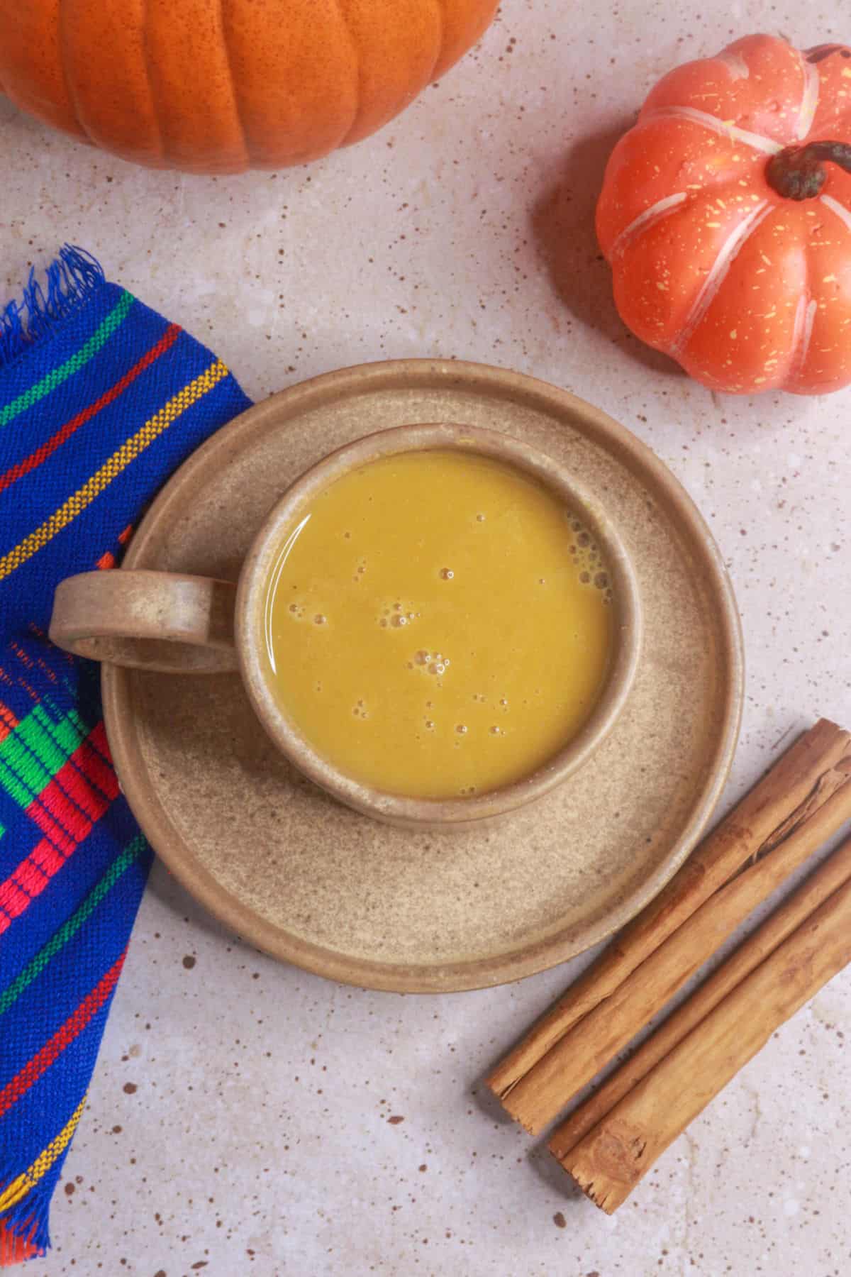 overhead view of a mug of atole de calabaza (pumpkin atole)