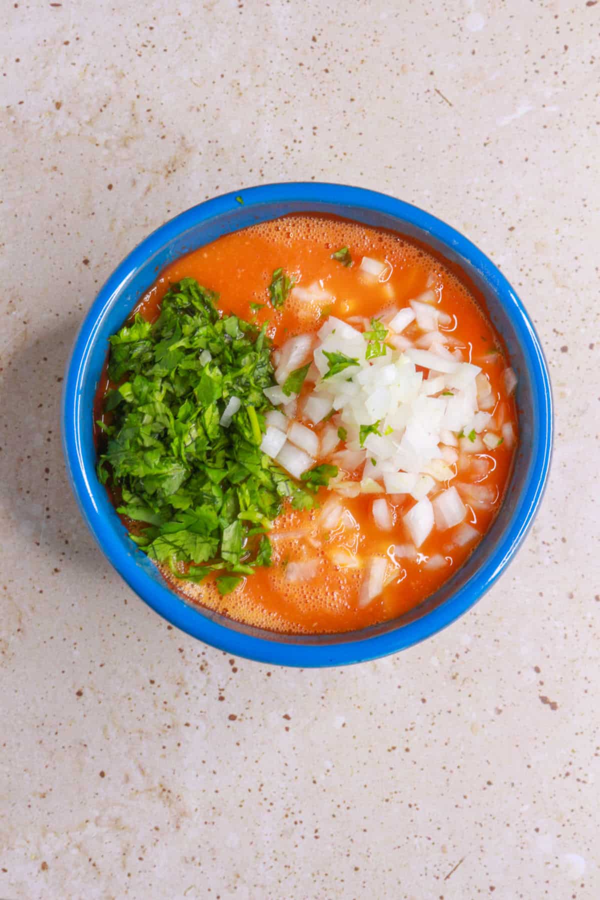 adding diced cilantro and onion to salsa