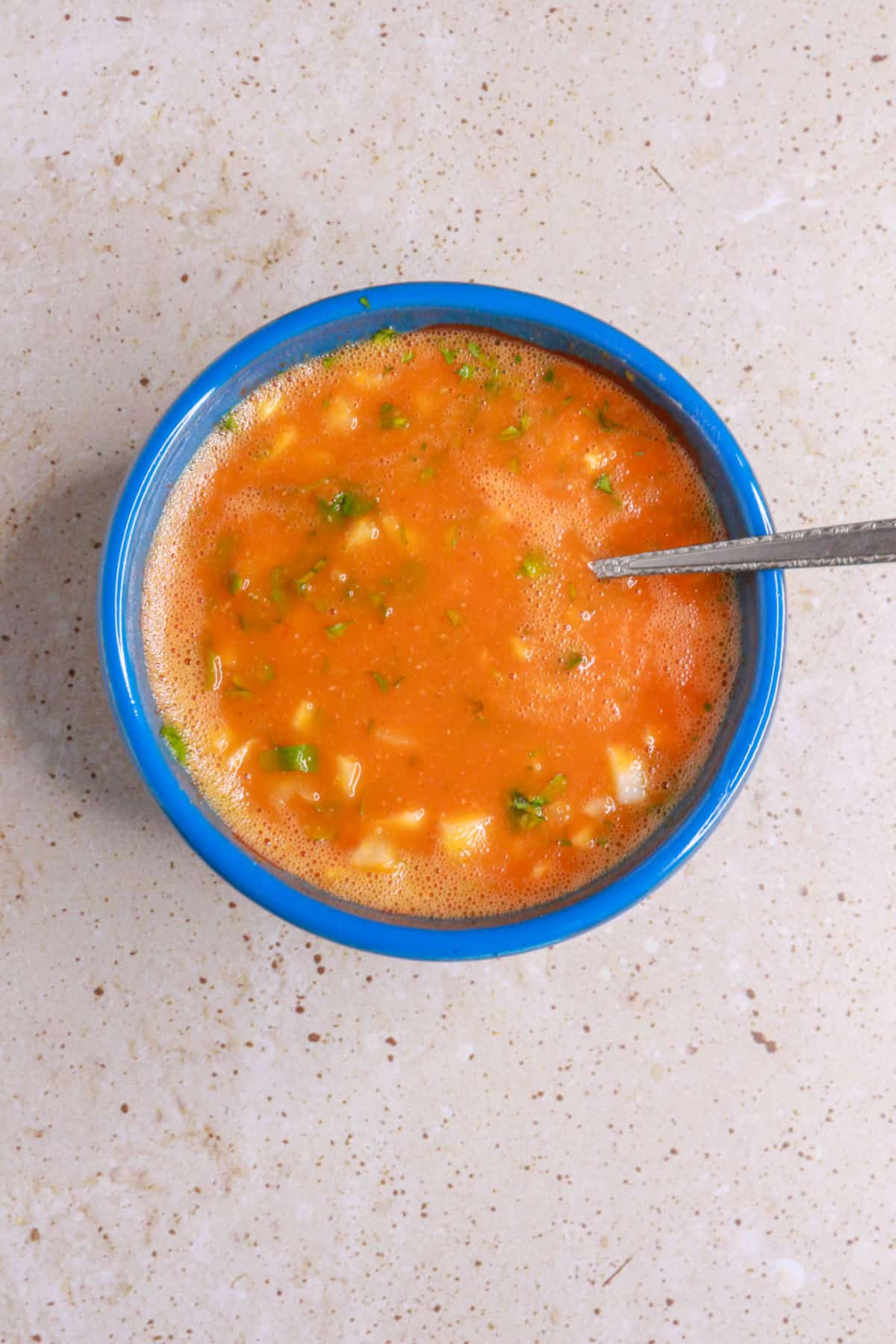 mixing chile de arbol salsa in salsa bowl