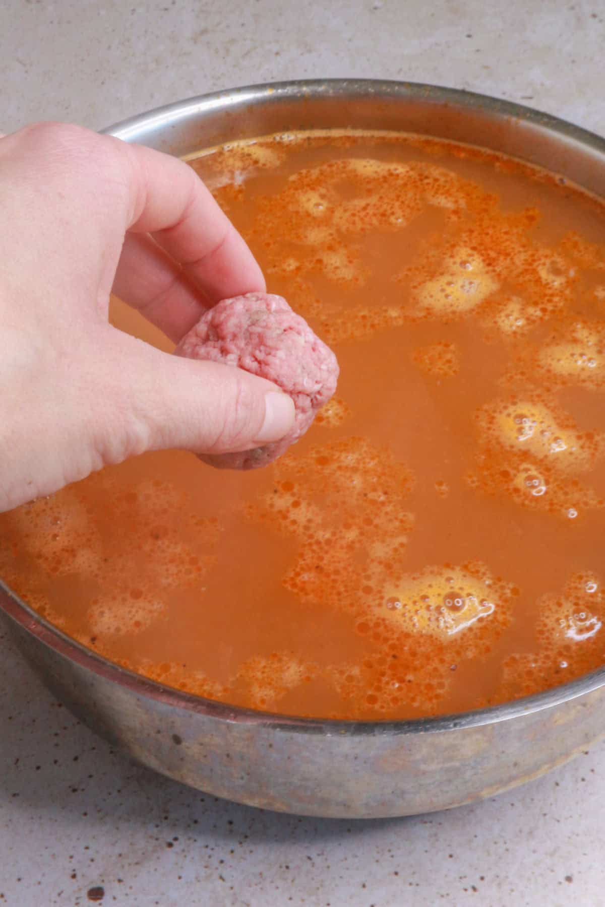 Adding meatballs to broth