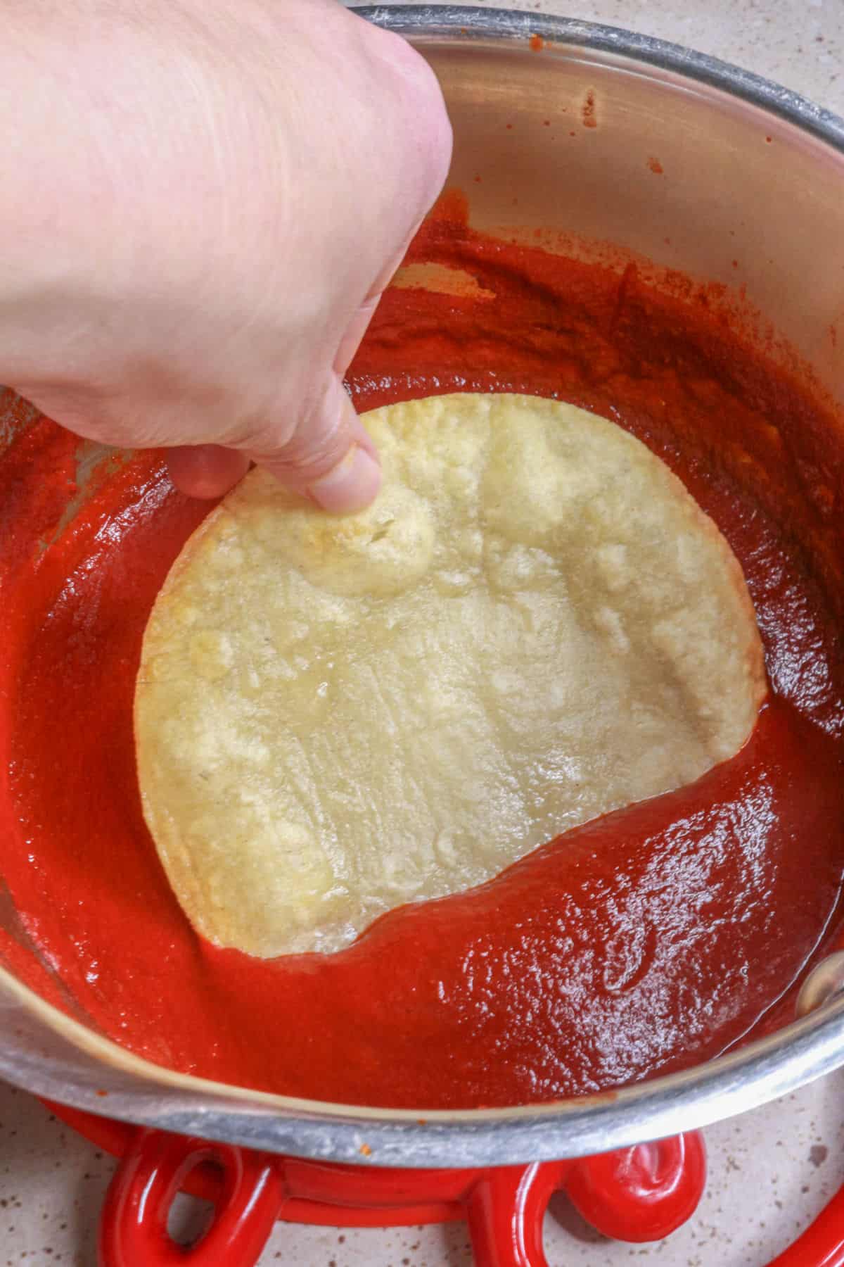 Dip each tortilla in enchilada sauce