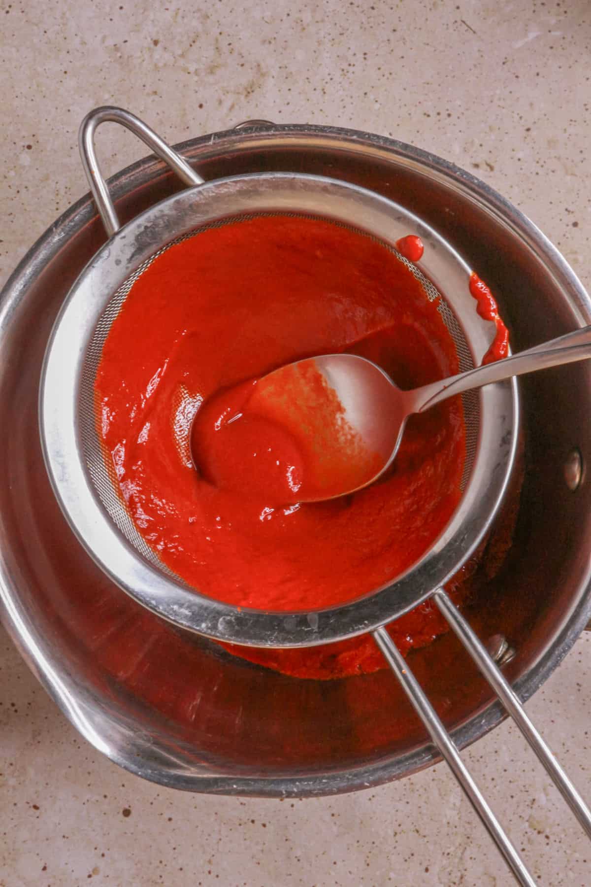 Strain sauce using a fine-mesh sieve