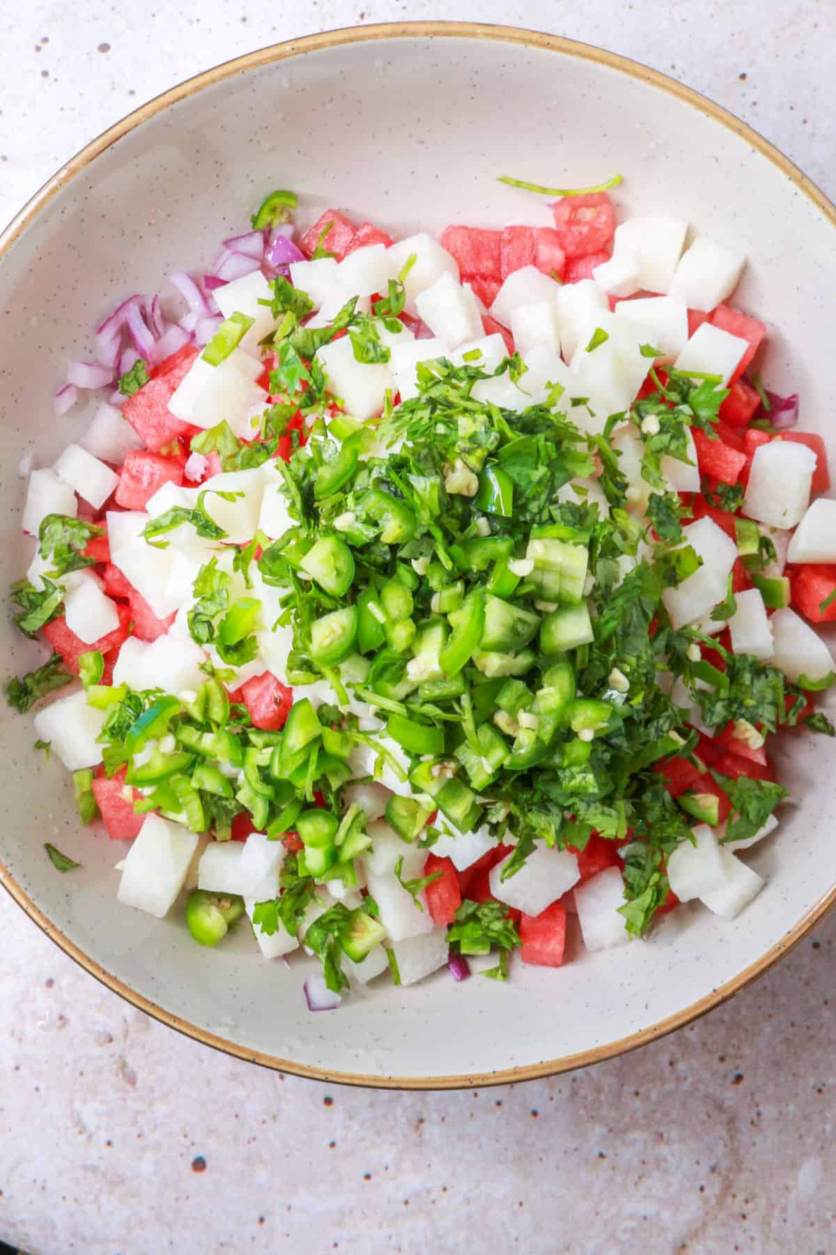 Combining ingredients for watermelon pico de gallo