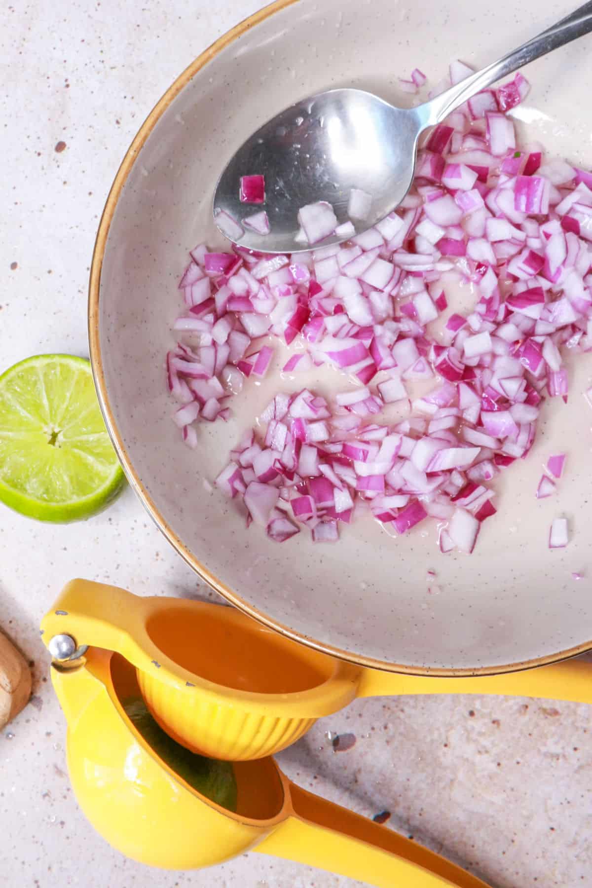 Diced onion in a bowl with lime and salt