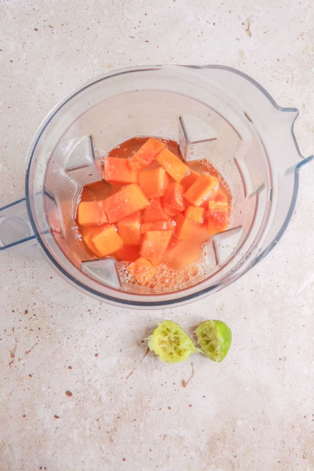 Papaya pieces, water and lime juice in a blender
