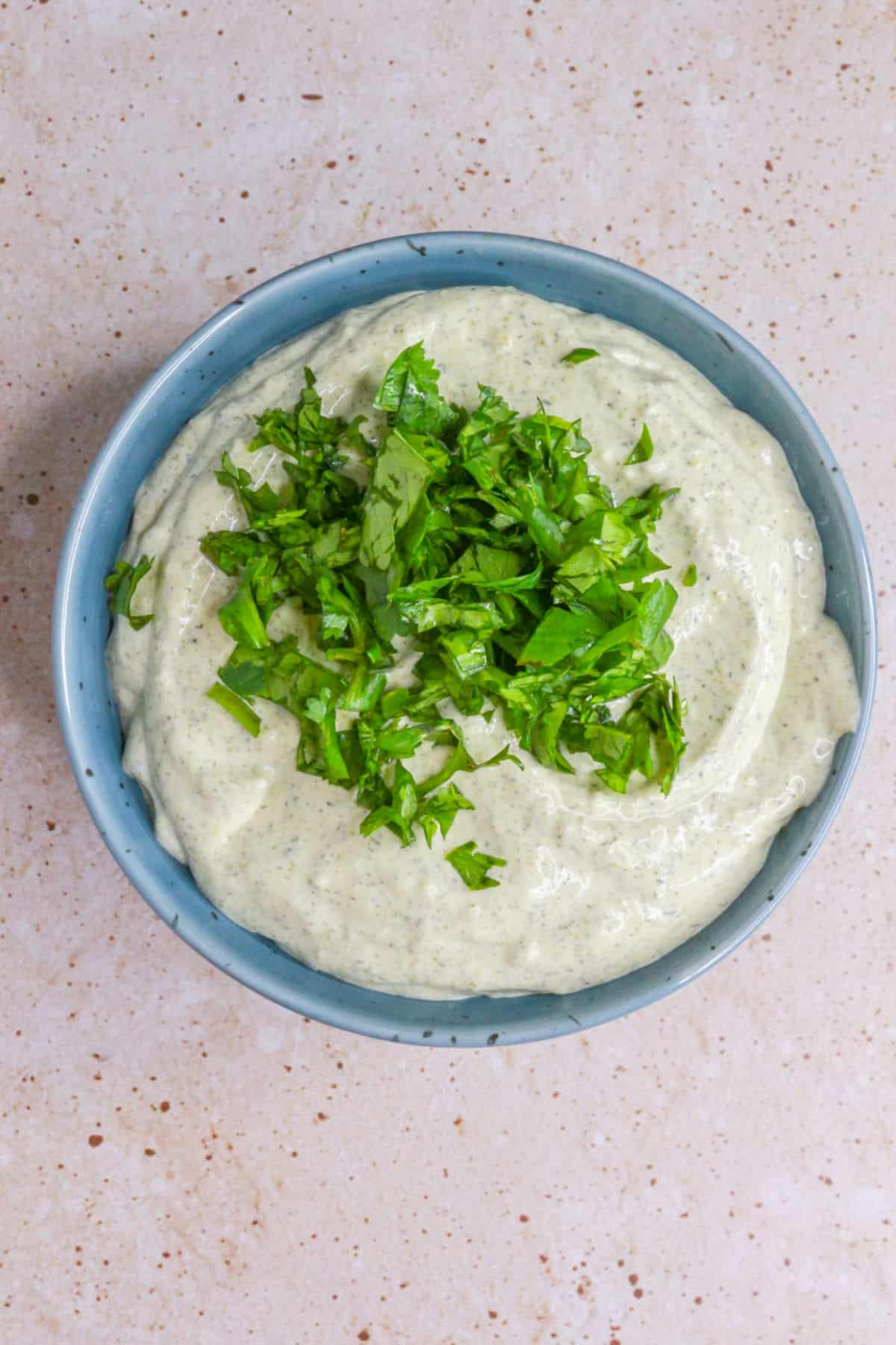 Jalapeño ranch dip in a bowl topped with fresh chopped cilantro