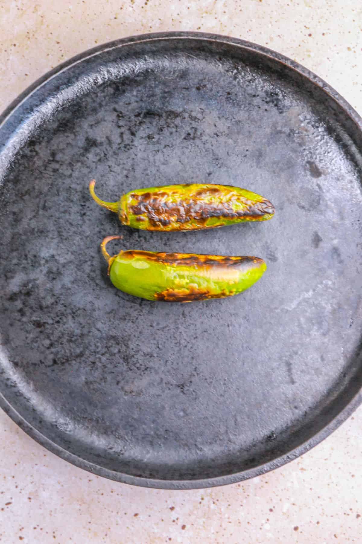 Roasted jalapeños on a comal