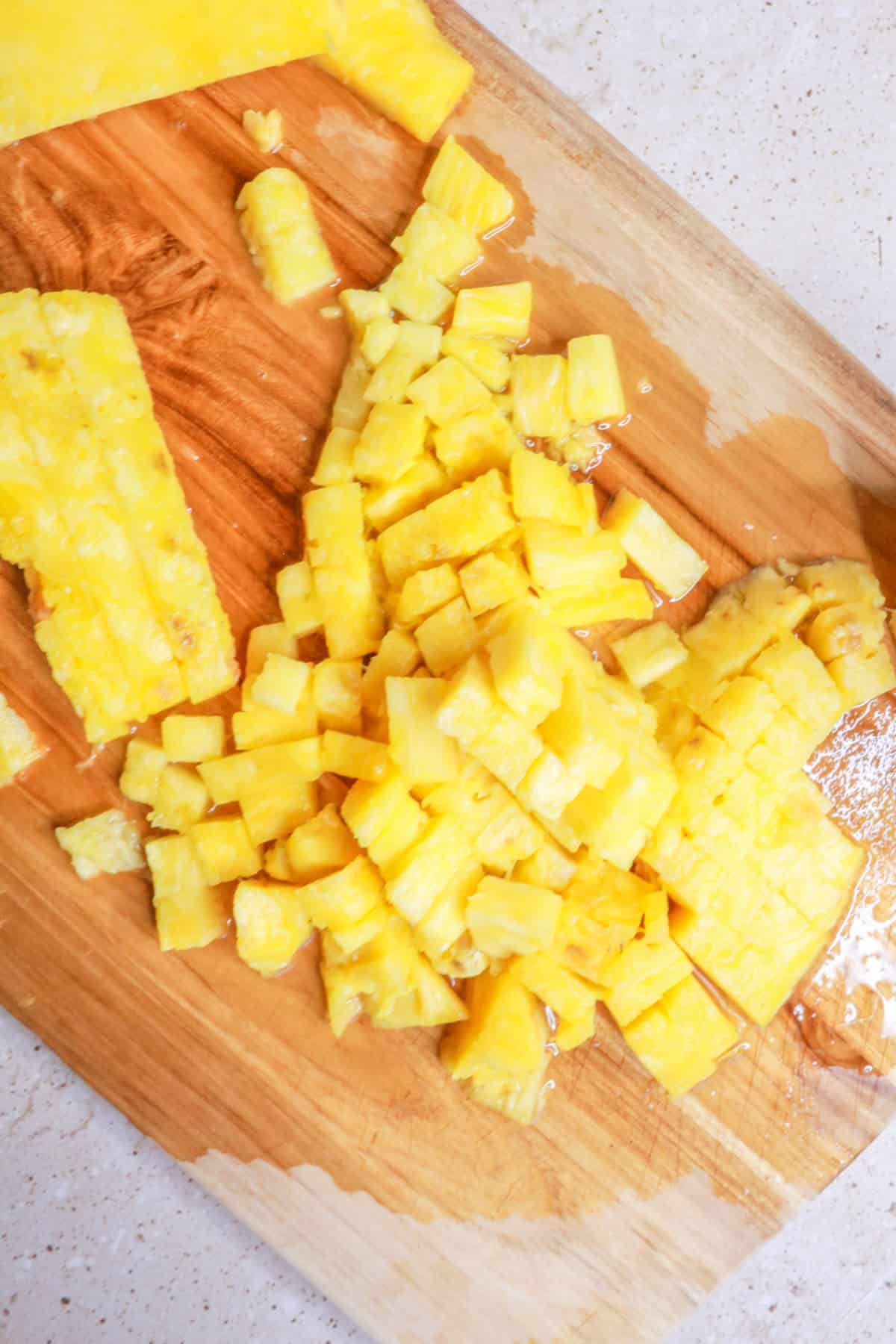 Chopped pineapple on cutting board