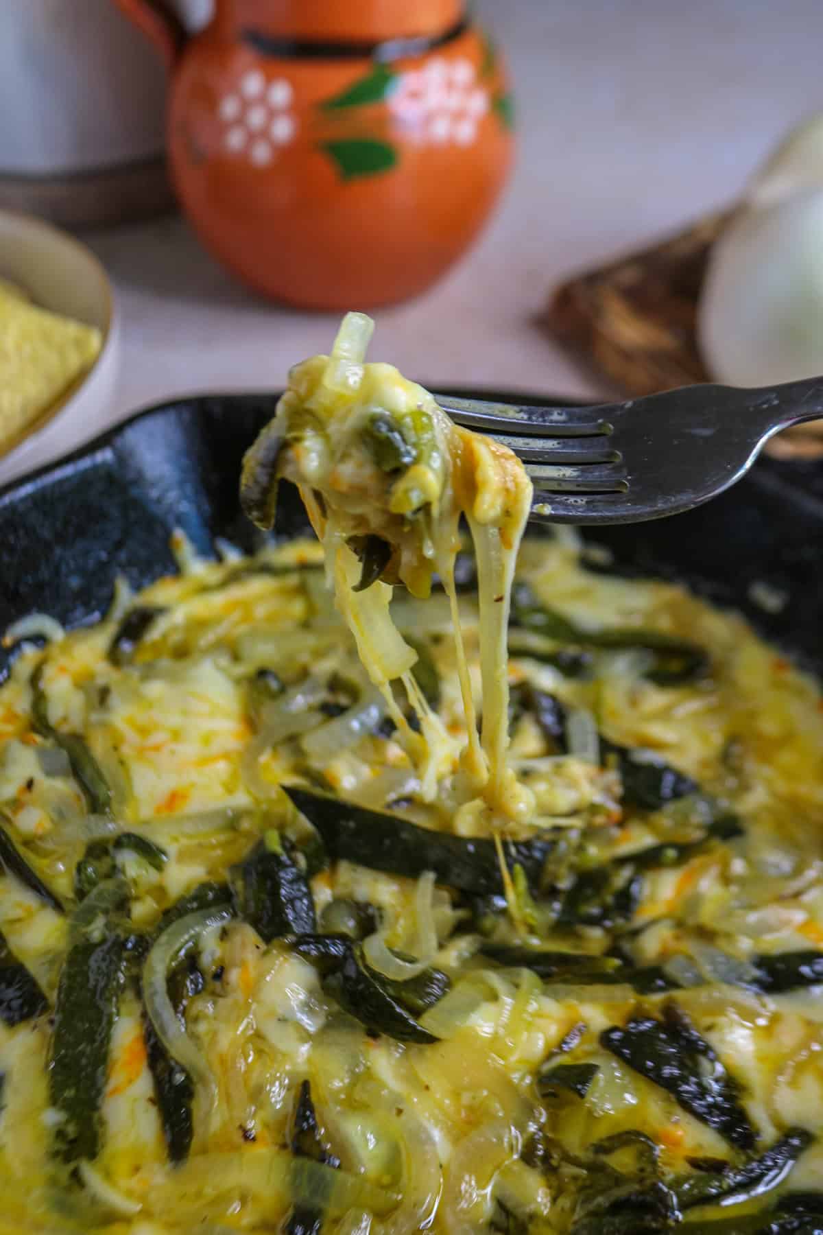 Cheese pull of Roasted Poblano Queso Fundido