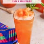 Close up of a glass of cantaloupe basil Agua Fresca garnished with pieces of melon and basil leaves