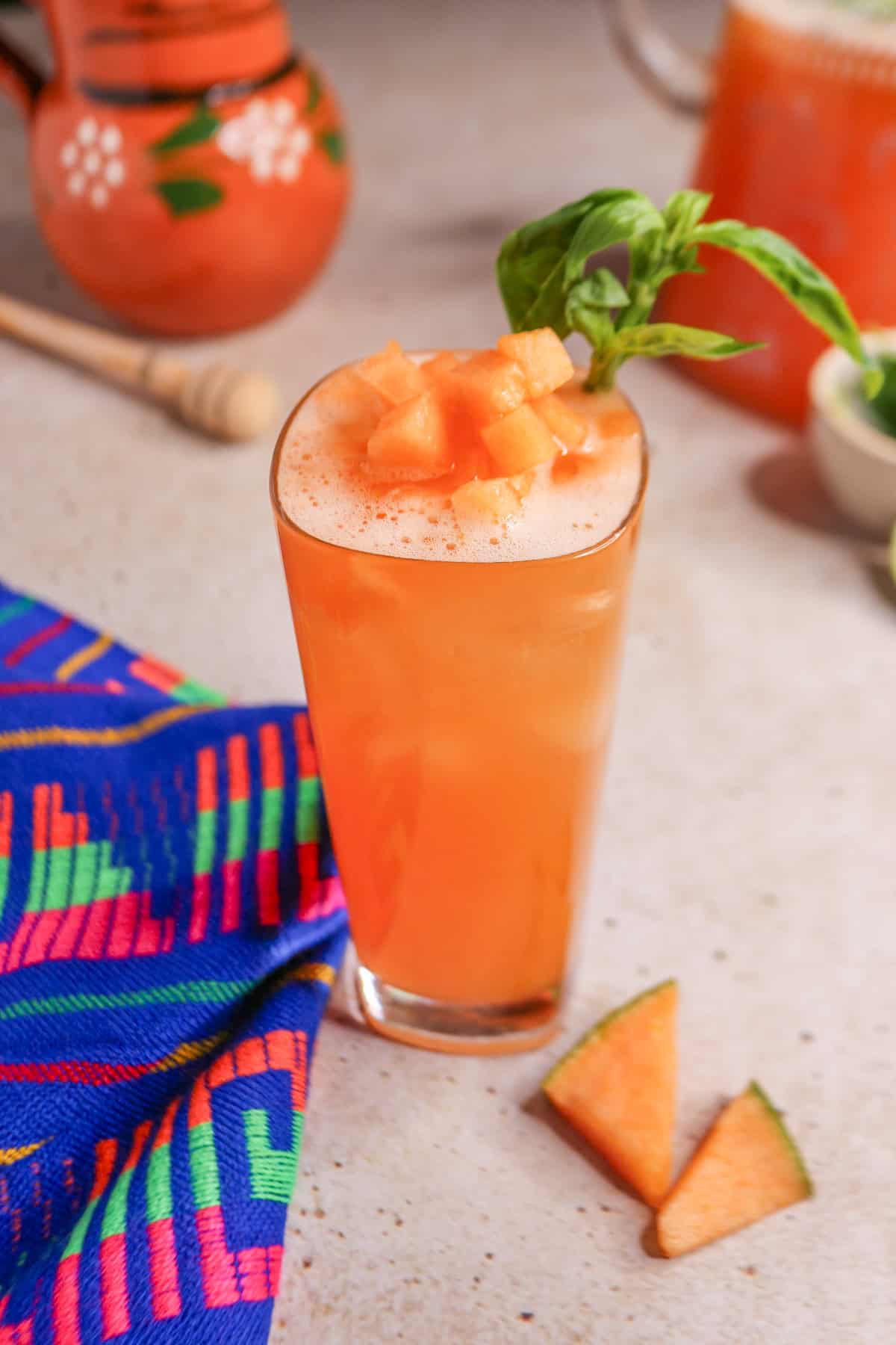 Glass of cantaloupe basil Agua Fresca garnished with basil