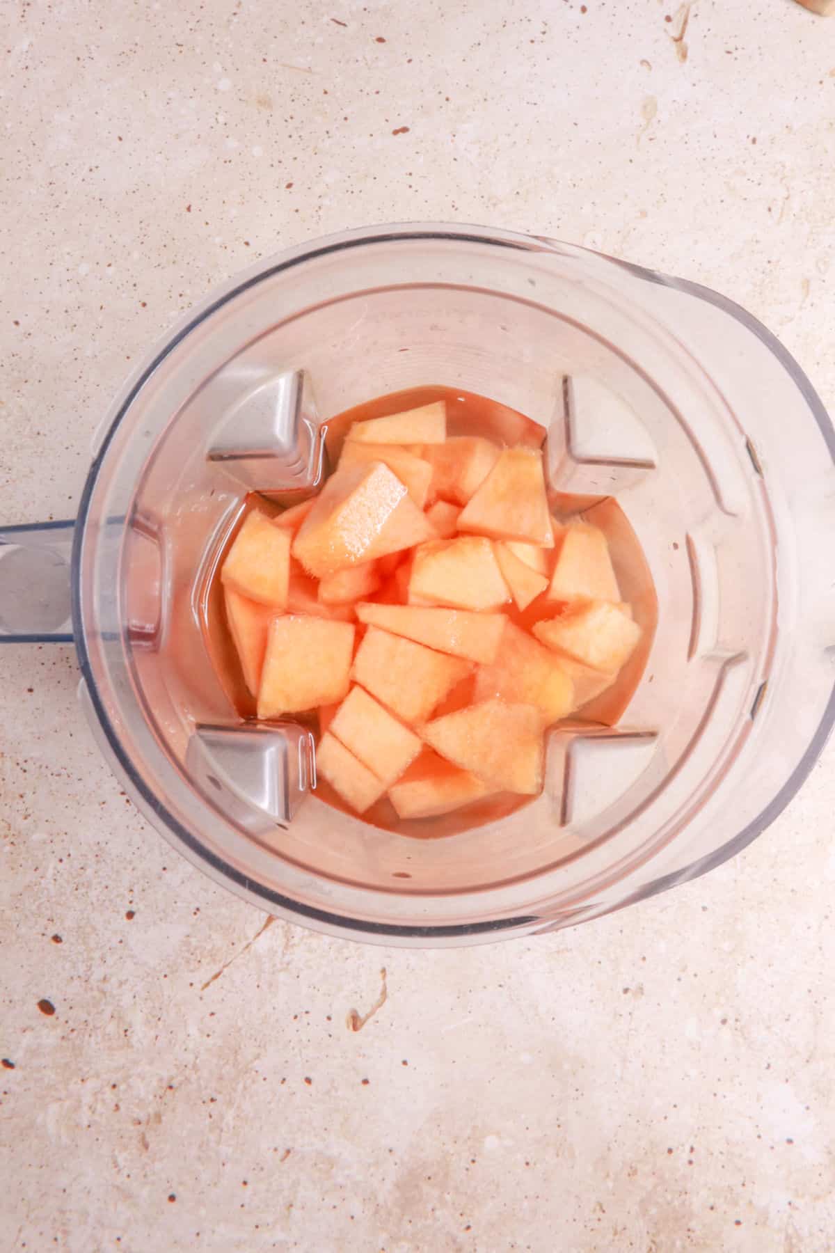 Chopped cantaloupe and water in a blender