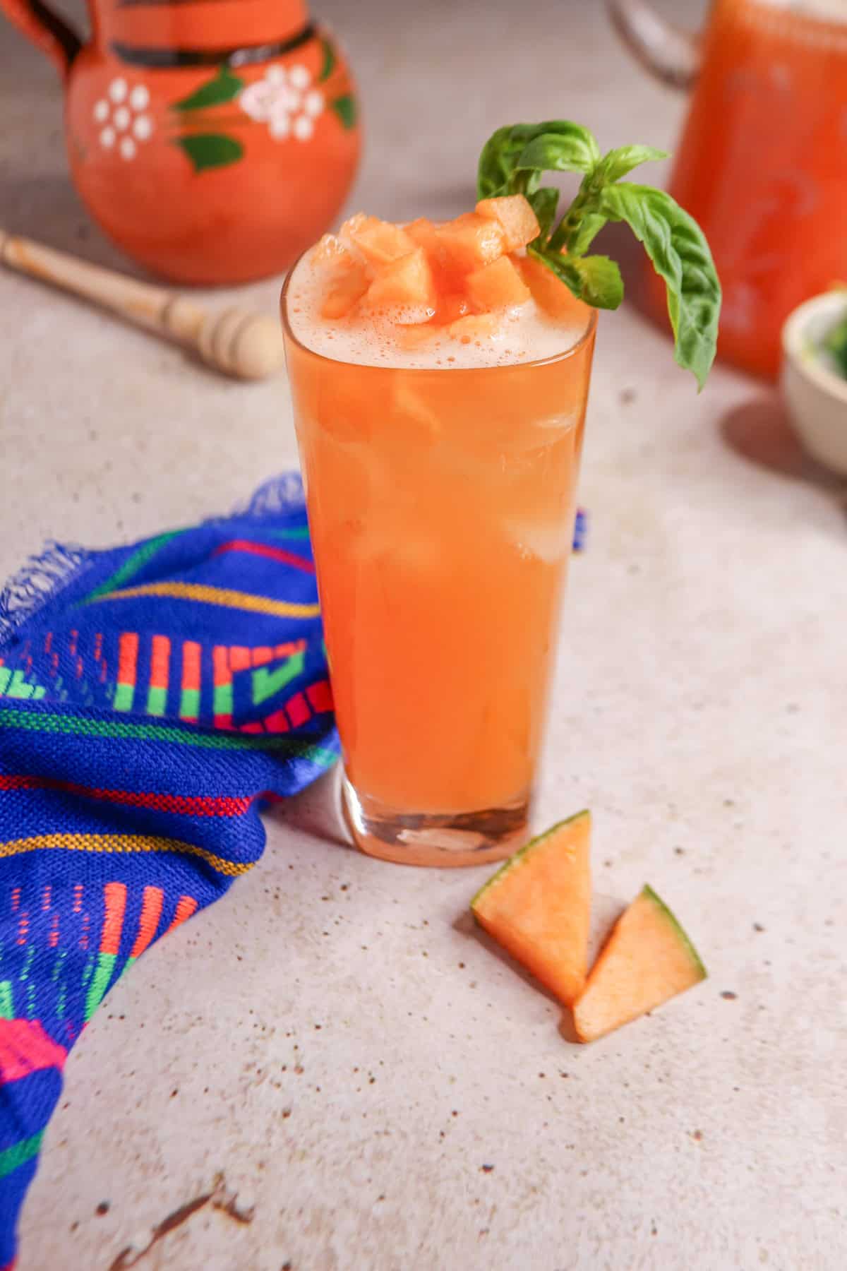 Glass of cantaloupe basil Agua Fresca garnished with basil